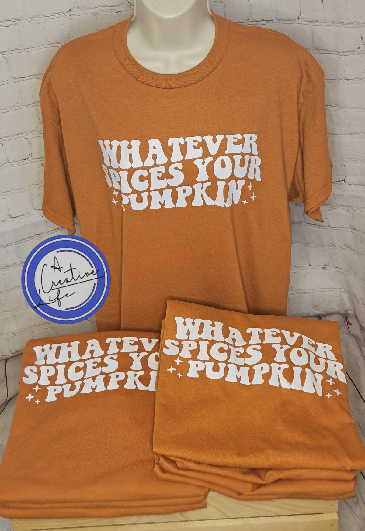 An orange t-shirt with whatever spices your pumpkin on it displayed on a mannequin.