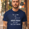 Man wearing a navy blue t-shirt with humorous text design.