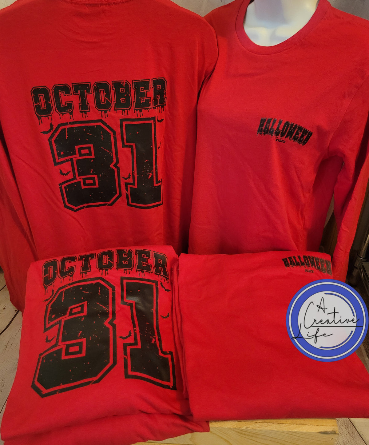 Two red t-shirts with 'Oct 31st - Halloween Vibes' text and some little bats, displayed on a mannequin.