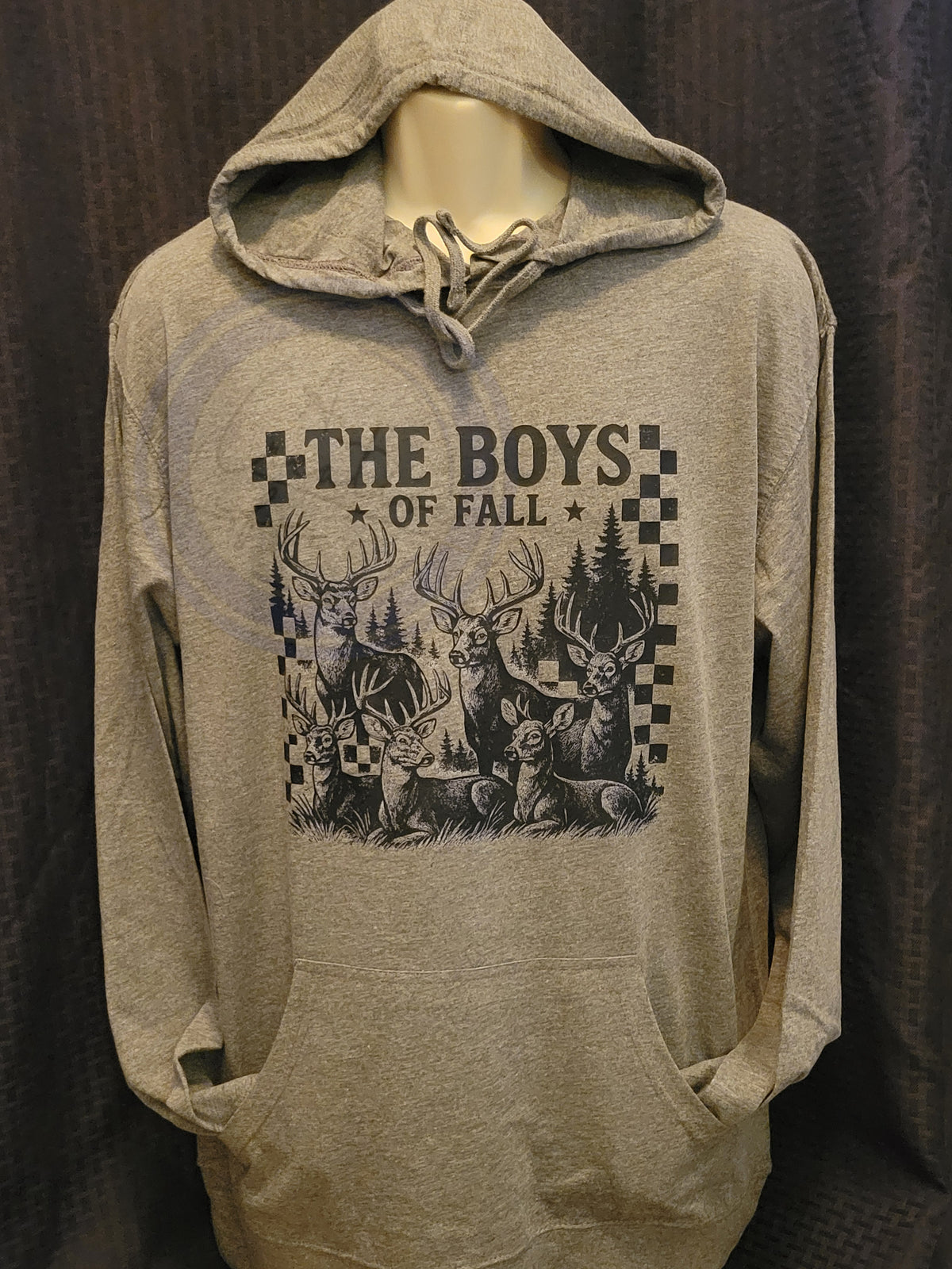 Gray hoodie with 'The Boys of Fall' graphic design on a dark background