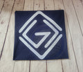 Navy blue fabric with a white geometric pattern on a wooden surface
