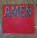 Red fabric with 'AMEN' in sequins on a wooden surface